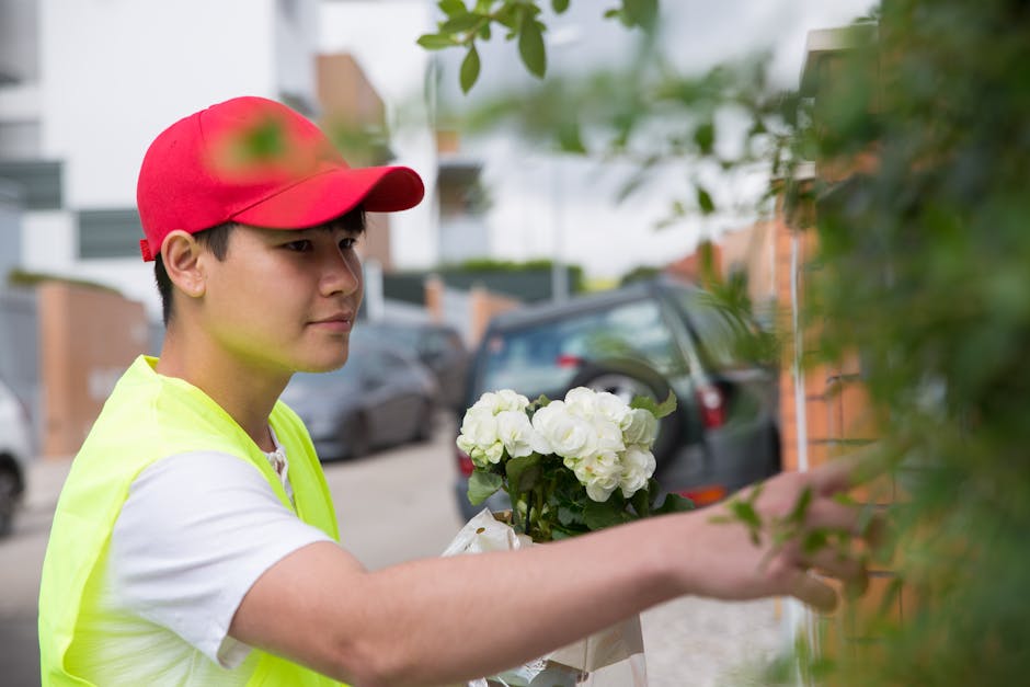 A young male flower delivery courier wearing a red cap and a neon yellow vest is depicted outdoors, delivering a bouquet of white hydrangeas wrapped in clear plastic. He is reaching out to place the f