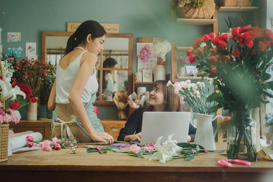 A florist and a customer engaging in a conversation inside a flower shop that offers flower delivery services discussed on the 'Common Problems with Online Florists Islington' page at flowersislington